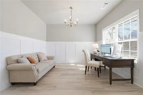 a living room with furniture and a chandelier