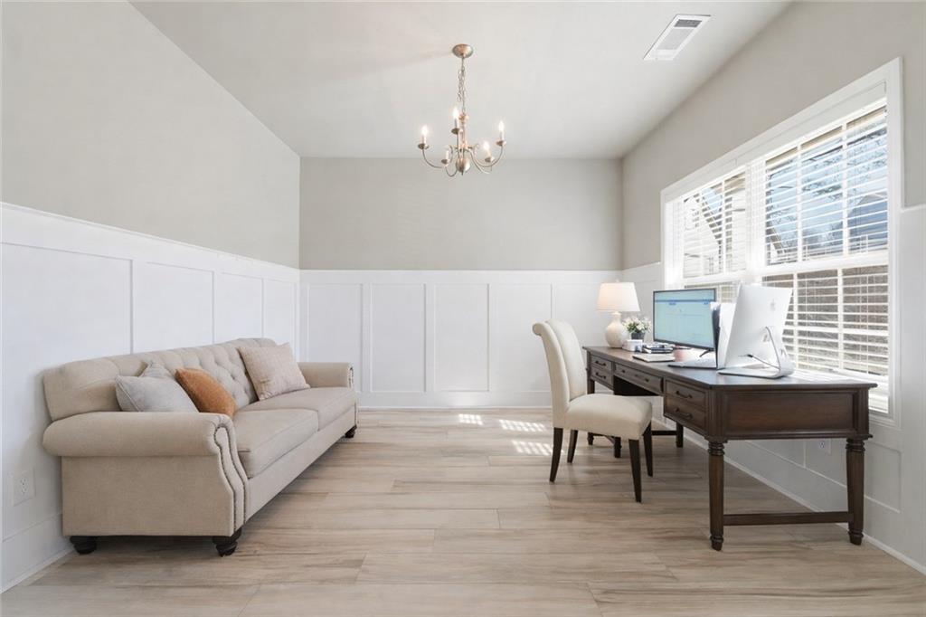 847 Wellford Avenue Jefferson, GA 30549 - Photo 12 of 33 a living room with furniture and a chandelier