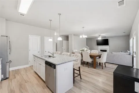 a large kitchen with a table and chairs