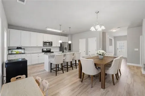 a view of kitchen with sink and breakfast area