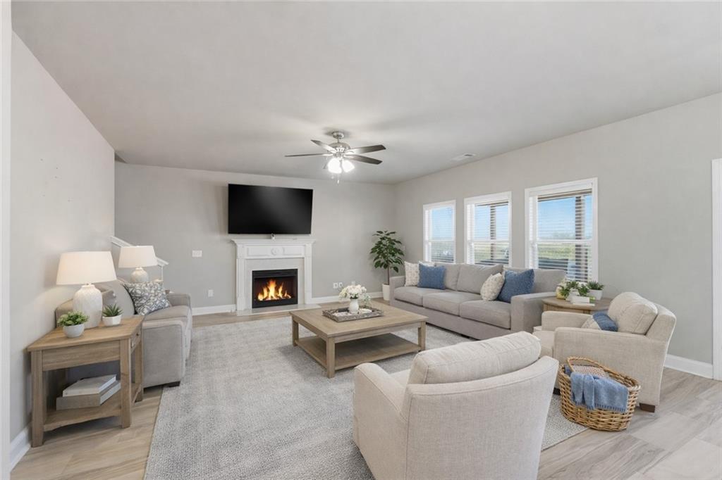 847 Wellford Avenue Jefferson, GA 30549 - Photo 19 of 33 a living room with furniture a fireplace and a flat screen tv