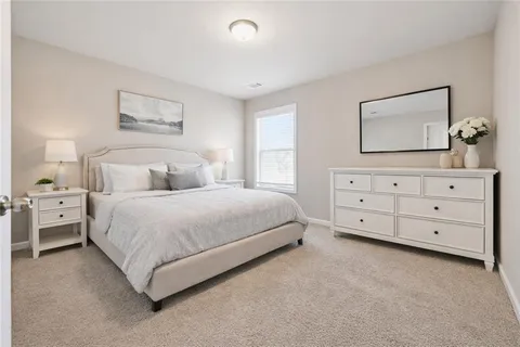 a bedroom with a bed and a night stand