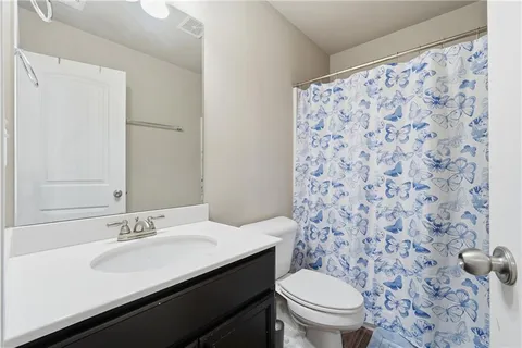a bathroom with a sink toilet and a mirror