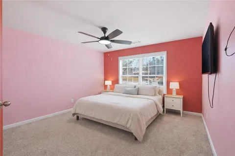 a bedroom with a bed dresser and a window