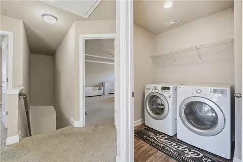 a view of a hallway with washer and dryer