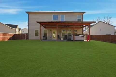 a view of a backyard with wooden fence