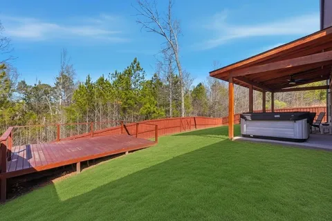 a view of porch with a table and chairs