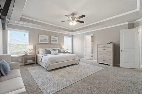 a spacious bedroom with a large bed and a couch