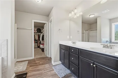 a spacious bathroom with a double vanity sink and a mirror