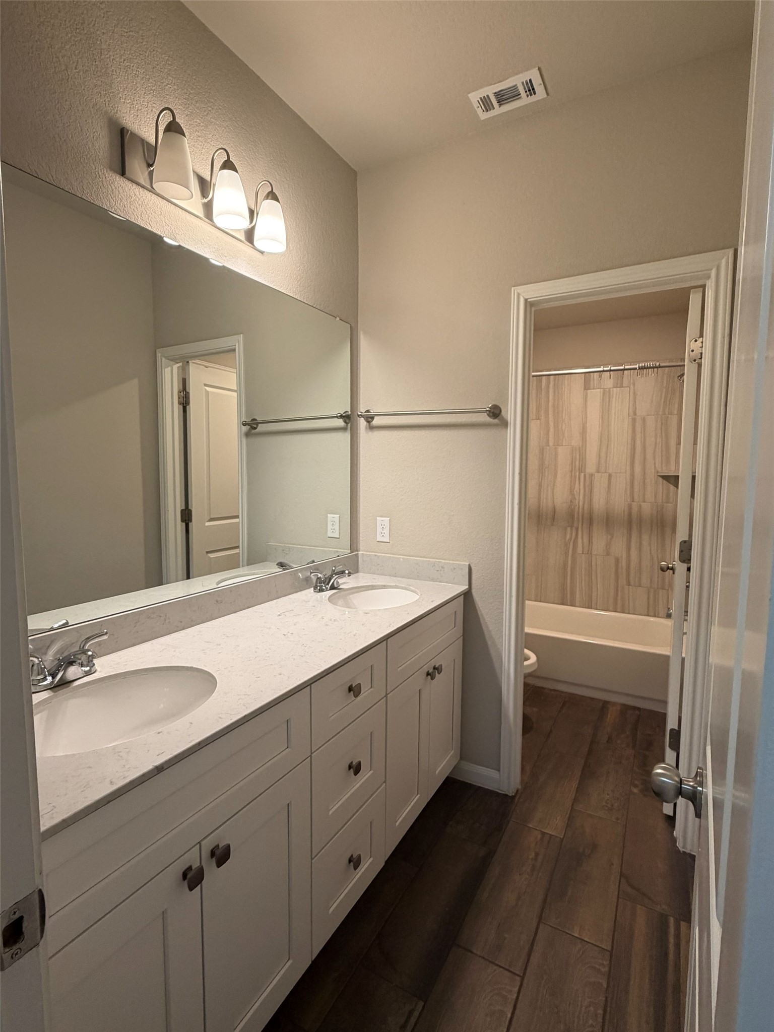 248 Falling Star Lane Georgetown, TX 78628 - Photo 8 of 16 Double vanity with stone counters provides ample space in this refreshed bathroom.