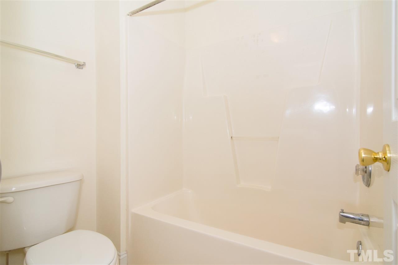4146 Standing Rock Way Raleigh, NC 27604 - Photo 14 of 18 a bathroom with a toilet and a bathtub