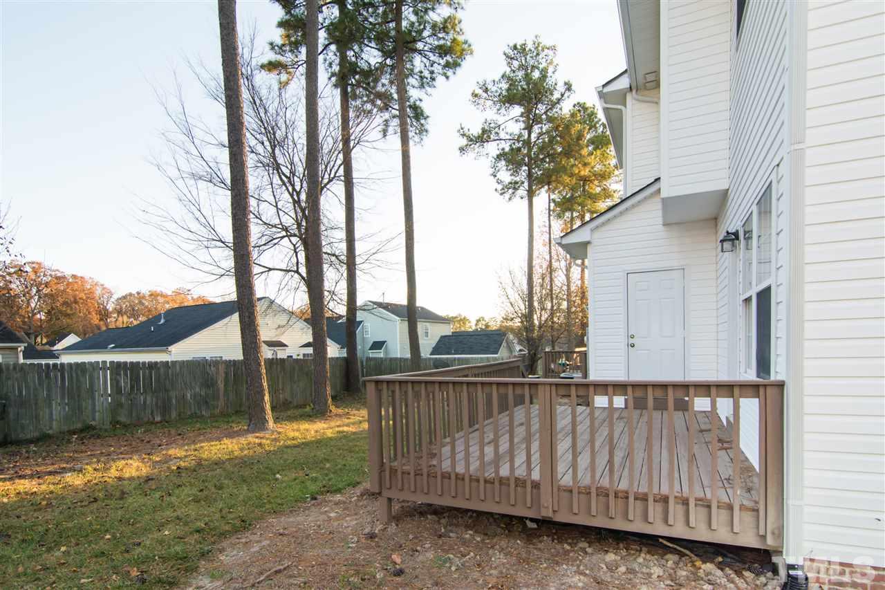 4146 Standing Rock Way Raleigh, NC 27604 - Photo 3 of 18 a view of a wooden deck next to a yard