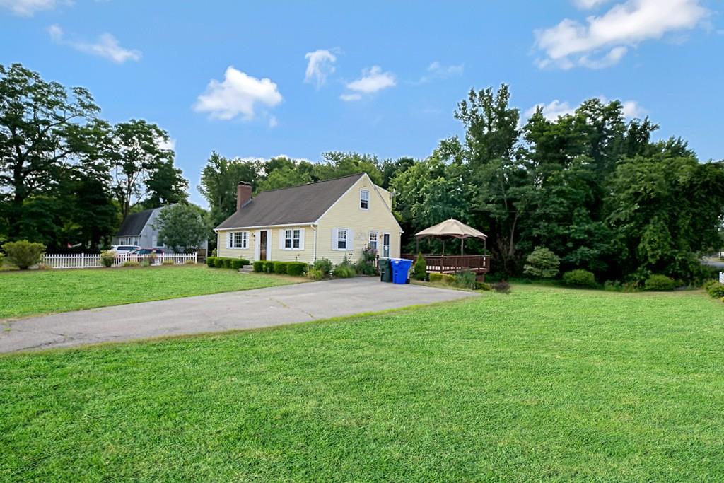159 Fair Oak Road Springfield, MA 01128 - Photo 2 of 21 a front view of a house with a garden and trees