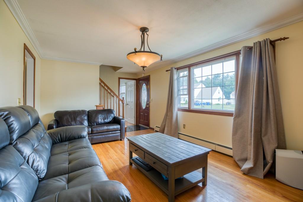 159 Fair Oak Road Springfield, MA 01128 - Photo 4 of 21 a living room with furniture a window and a chandelier