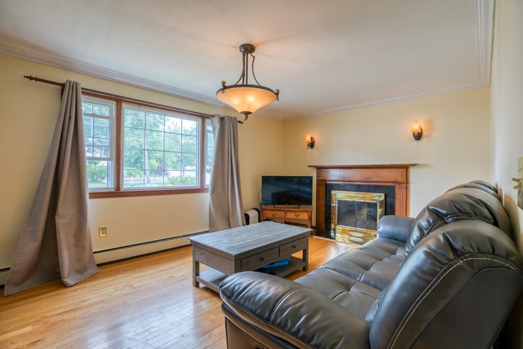 159 Fair Oak Road Springfield, MA 01128 - Photo 5 of 21 a living room with furniture a ceiling fan and a fireplace