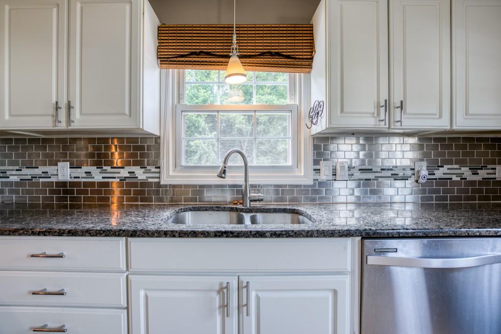 159 Fair Oak Road Springfield, MA 01128 - Photo 7 of 21 a kitchen with granite countertop white cabinets and a window
