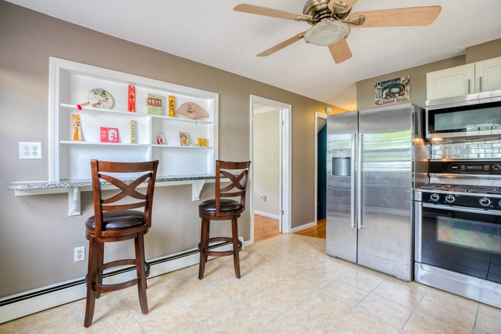 159 Fair Oak Road Springfield, MA 01128 - Photo 8 of 21 a view of a kitchen with furniture and a ceiling fan