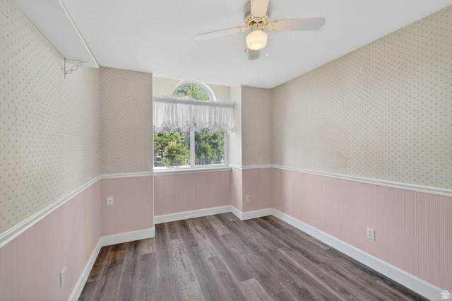 1464 990 West Provo, UT 84601 - Photo 24 of 41 Room featuring wood-finish flooring, a ceiling fan with integrated lighting, and a window with an arched transom