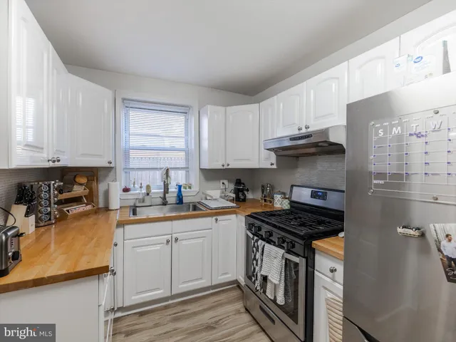 a view of a workspace with furniture and wooden floor