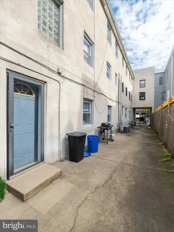 a living room with furniture a window and a clock