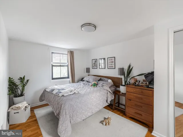 a kitchen with a refrigerator a stove a sink dishwasher and white cabinets with wooden floor