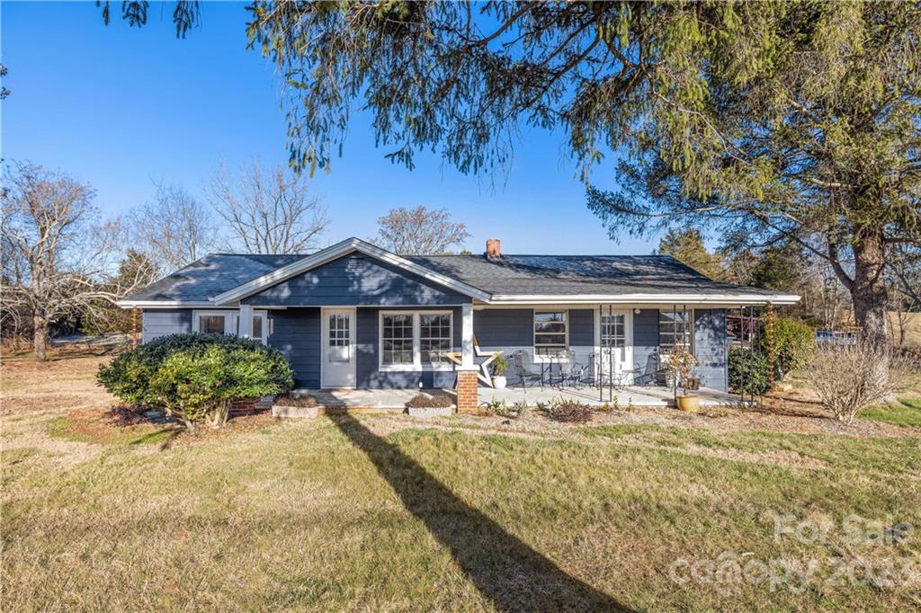 7135 Highway 108 Mill Spring, NC 28756 - Photo 3 of 48 a front view of a house with garden