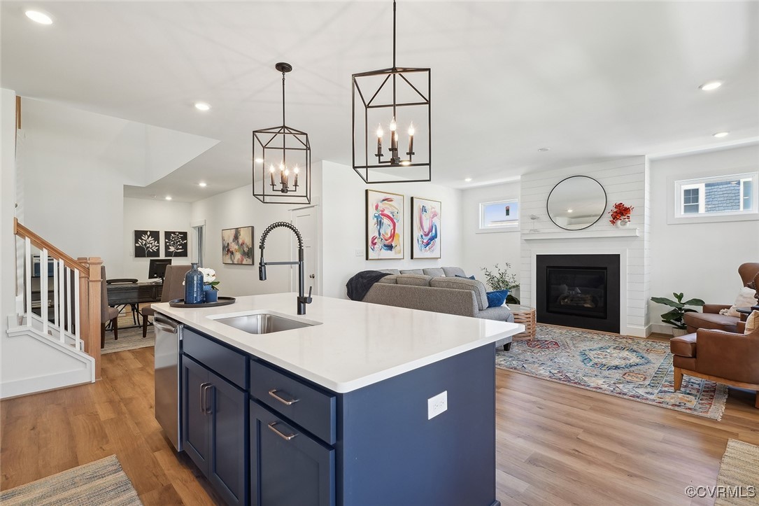 7600 Oak Grove Tree Drive Chesterfield, VA 23832 - Photo 11 of 17 a living room with kitchen island a sink dishwasher a fireplace with wooden floor