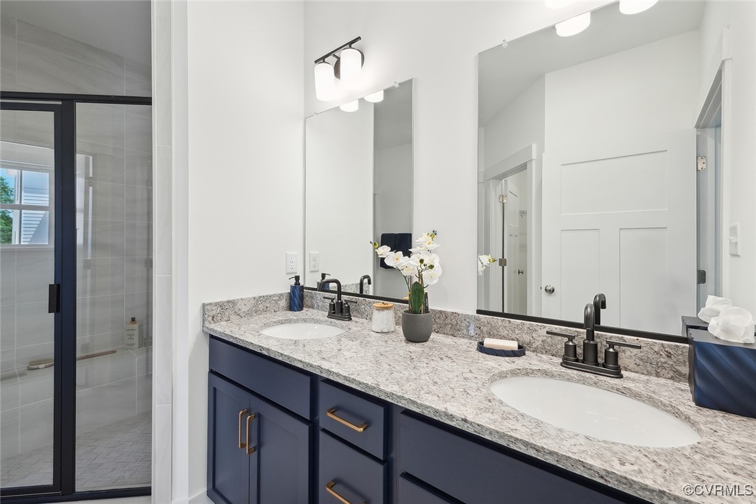 7600 Oak Grove Tree Drive Chesterfield, VA 23832 - Photo 12 of 17 a bathroom with a granite countertop double vanity sink and a mirror