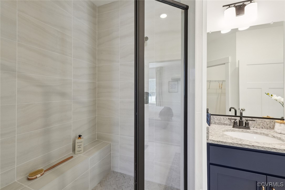 7600 Oak Grove Tree Drive Chesterfield, VA 23832 - Photo 13 of 17 a bathroom with a granite countertop sink a toilet and shower