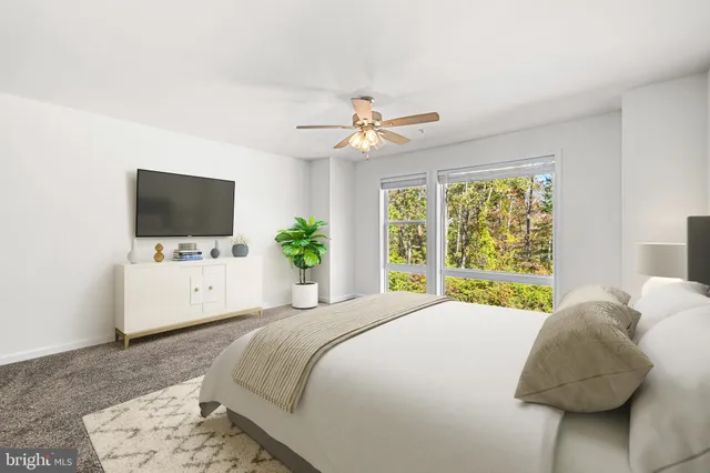 a bedroom with a flat screen tv bed and a flat screen tv
