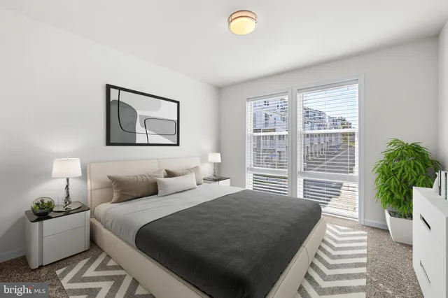 a bedroom with a bed and a large window