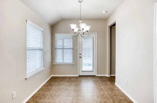 a view of a chandelier in a livingroom with a window