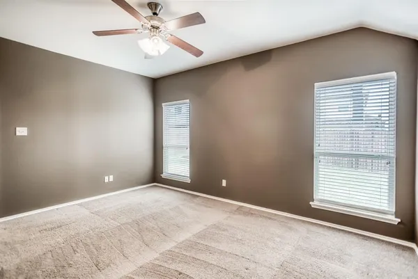 a view of a livingroom with a ceiling fan and window