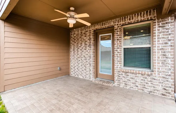 a view of a porch with a door and a ceiling fan
