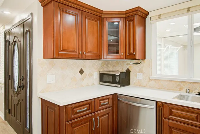 a kitchen with stainless steel appliances granite countertop a refrigerator and a sink