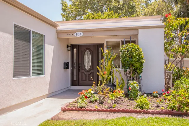 a front view of a house with garden