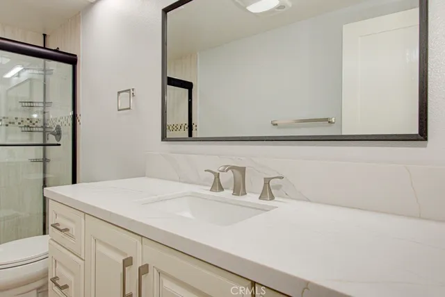 a bathroom with a toilet a sink and a shower