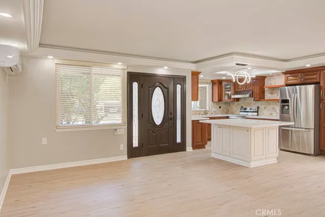 a open kitchen with white cabinets and white appliances