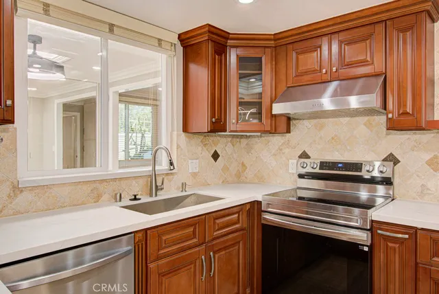 a kitchen with stainless steel appliances granite countertop a sink and cabinets