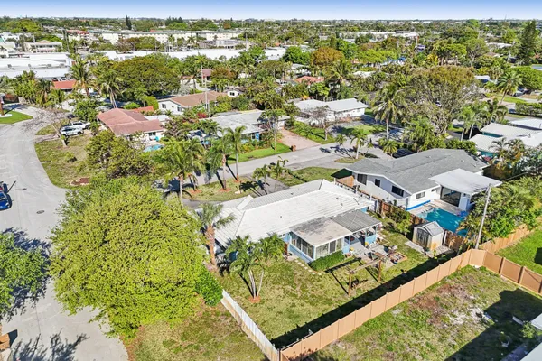 an aerial view of a house with a yard and a fountain
