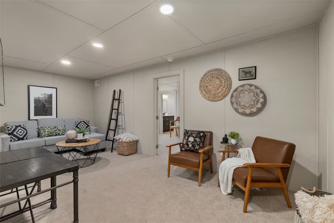 a living room with furniture and a clock