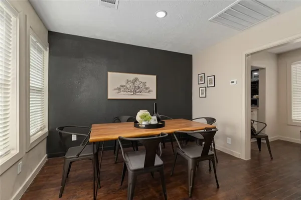 a view of a dining room with furniture and wooden floor