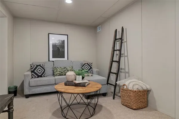 a living room with furniture and a potted plant