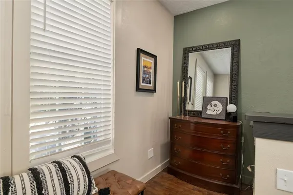 a view of a hallway with a dresser and couch