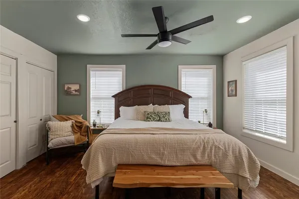 a bedroom with a bed and wooden floor