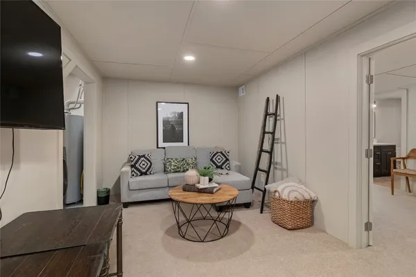 a living room with furniture a window and a flat screen tv