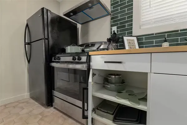 a kitchen with appliances and cabinets