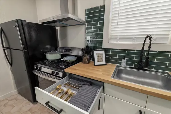 a kitchen with a sink and a stove