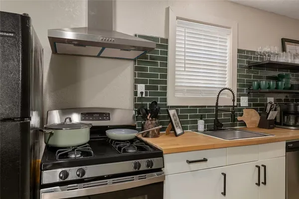 a kitchen with a stove and a sink