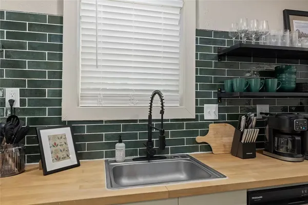 a view of a sink and dishwasher with wooden floor